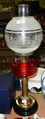 Lot 53 - A late 19th/early 20th century brass oil lamp with red glass