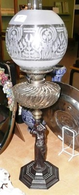 Lot 87 - A spelter oil lamp and a hanging oil lamp