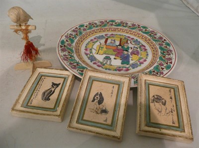 Lot 102 - An early 20th century carved ivory figure of a parrot, three small painted plaques and a 20th...