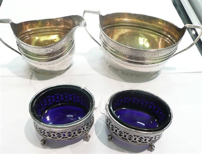 Lot 155 - A silver bright cut sugar bowl and cream jug and a pair of Brittannia metal salts, 13oz approximate