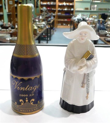 Lot 165 - A Worcester candle snuffer in the form of a Nun together with a Millennium vintage champagne bottle