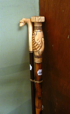 Lot 177 - A walking stick with carved bone handle and another