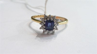 Lot 312 - A sapphire and diamond cluster ring