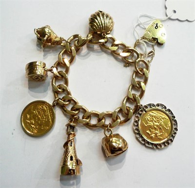 Lot 338 - A 9ct gold charm bracelet set with two sovereigns