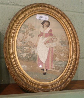 Lot 369 - A gilt framed needlework picture of a lady picking flowers