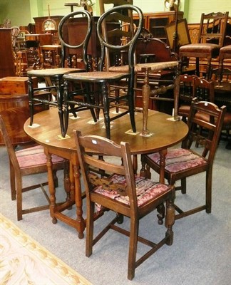 Lot 450 - A dining table, four chairs, a wicker chair and two black lacquer chairs