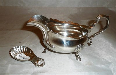 Lot 112 - Silver sauce boat and a shell shaped caddy spoon, 6oz