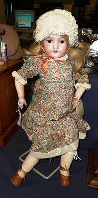 Lot 126 - Armand Marseille bisque socket head doll with blond hair in a floral dress