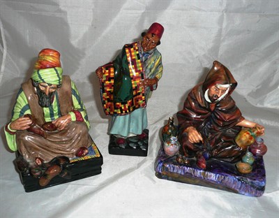 Lot 153 - Three Royal Doulton figurines, HN1464 'Carpet Seller', HN1493 'The Potter' and HN1706 'Cobbler'