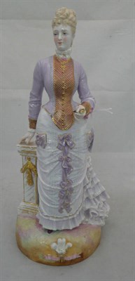 Lot 207 - A French porcelain figure of the Princess of Wales, late 19th century, standing wearing a lilac...