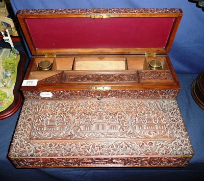 Lot 270 - An Indian carved wood portable writing box, circa 1900, the lidded superstructure carved in...