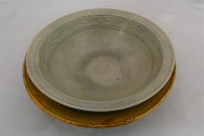 Lot 282 - A celadon glazed bowl, two others and a bronze plaque