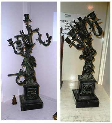 Lot 284 - A pair of 19th century bronze candelabrum modelled as cherubs holding branches