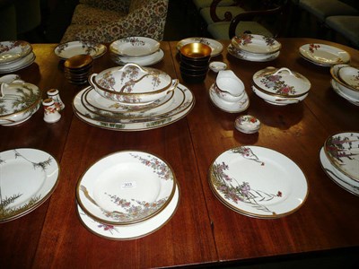 Lot 303 - Japanese dinner service, each piece decorated with foliage, highlighted in gilt