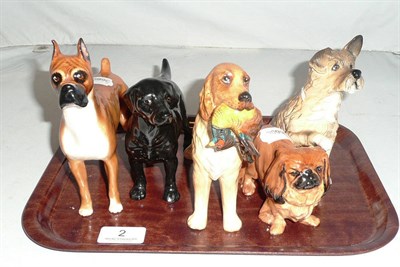 Lot 2 - Four Royal Doulton dogs and an Alton china retriever with pheasants
