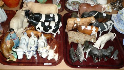 Lot 12 - Seven Beswick cattle, pottery cow creamers, etc on two trays