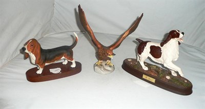 Lot 16 - Doulton spaniel on plinth, Beswick Bassett hound on plinth and a Golden Eagle
