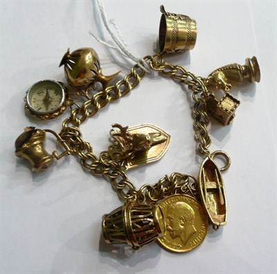 Lot 92 - A charm bracelet hung with eight gold charms, another and a 1925 soldered sovereign