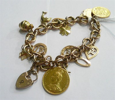Lot 98 - A charm bracelet hung with a soldered 1914 half sovereign and an 1887 full sovereign