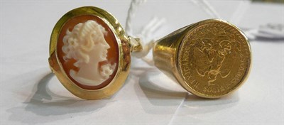 Lot 99 - A cameo ring stamped '750' and a Peso ring