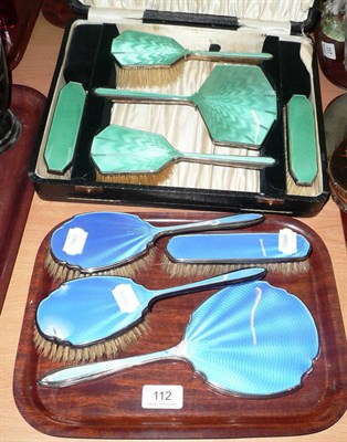 Lot 112 - A cased silver and enamel five piece dressing table set and another four piece set (damages)