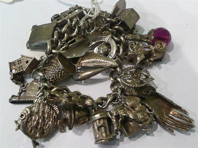 Lot 173 - A silver charm bracelet and two silver brooches
