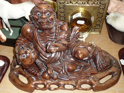 Lot 34 - A carved Chinese rootwood figure group on stand