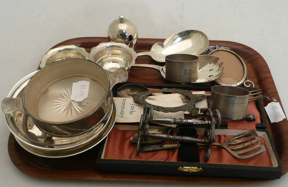 Lot 39 - Assorted silver teaspoons, servers, two silver napkin rings, pair of knife rests, photo frame...