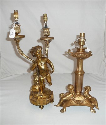 Lot 45 - Gilt metal table lamp on tripod feet with cherub figures and a cherub two branch table lamp