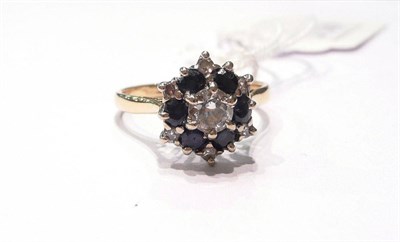 Lot 88 - A diamond and sapphire cluster ring
