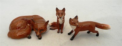 Lot 111 - Beswick seated fox and two other smaller foxes (3)
