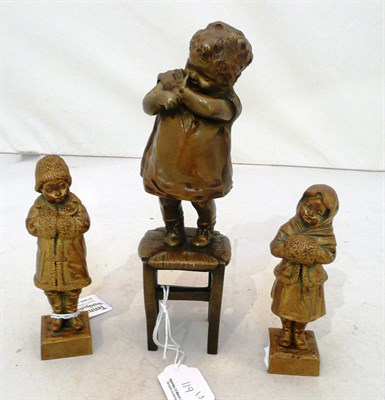 Lot 119 - Pair of bronze figure groups of two young children in winter clothes signed 'Le Guluhe' and another