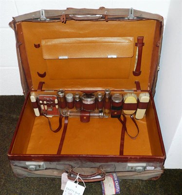 Lot 158 - Leather suitcase with complete silver-plate topped travelling set and manicure set