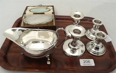 Lot 206 - A silver sauce boat (3oz), two pairs of (loaded) dwarf candlesticks and a boxed brush