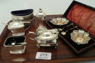 Lot 213 - A silver three piece cruet set, a silver mustard, a silver salt with blue glass liner and a...