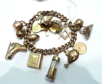 Lot 228 - A charm bracelet hung with assorted charms