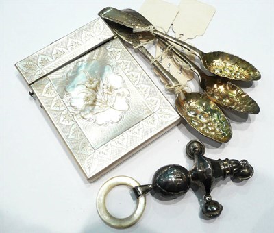 Lot 238 - Three silver berry spoons, a card case and a silver rattle