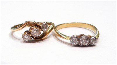 Lot 246 - Two 18ct gold diamond cross-over rings