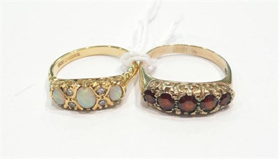 Lot 271 - An 18ct gold opal and diamond ring and a garnet five stone ring