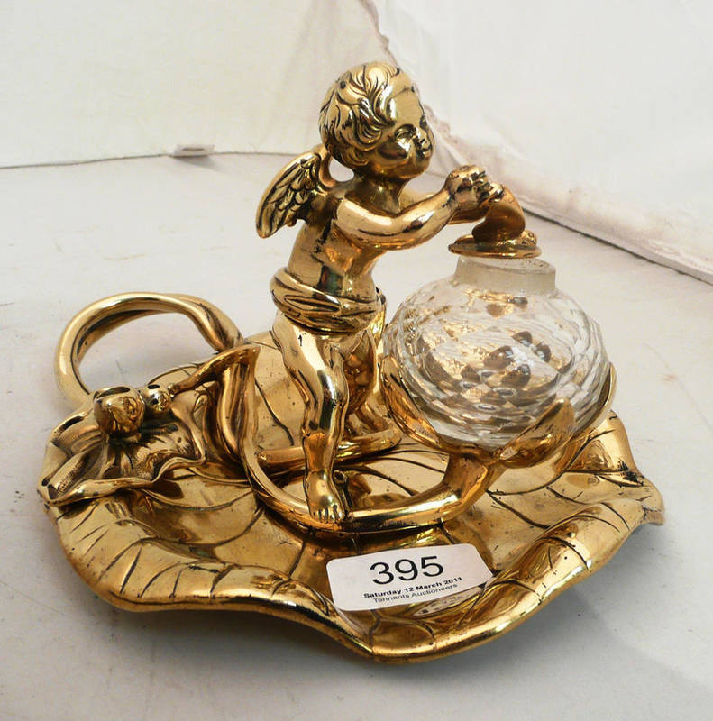 Lot 395 - A Victorian brass inkwell modelled as a cherub on a lily