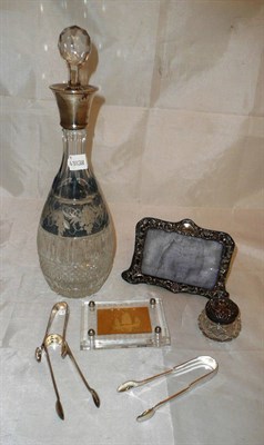 Lot 5 - A cut glass decanter with silver collar, three pairs of sugar tongs, silver photo frame, a...