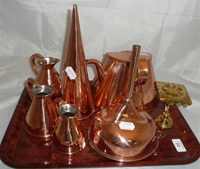 Lot 48 - A copper ale muller, a funnel, three copper measures, a brass trivett and a kettle