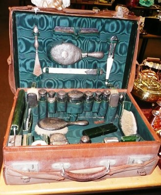 Lot 49 - Leather travelling case with silver mounted bottles and other fittings