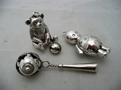 Lot 75 - A Googlie doll rattle and two others