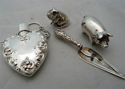 Lot 76 - Two silver miniature pigs (2oz approximately), a heart scent bottle and a bookmark