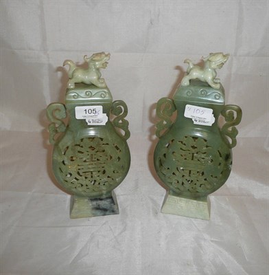 Lot 105 - A pair of Chinese carved and pierced jade type vases and covers, 20th century