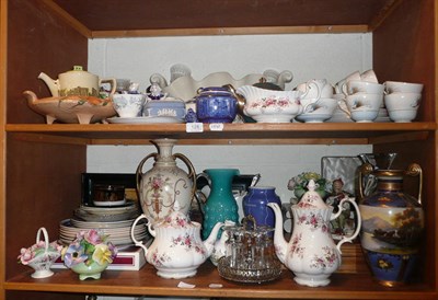 Lot 128 - Two shelves of decorative ceramics, glass and ornamental items including cased silver...