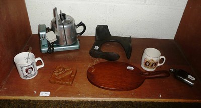 Lot 144 - A Thompson of Kilburn wooden cheese board, a ships wheel, a cast iron shoe last, a Beaverman...