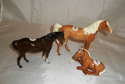 Lot 169 - Beswick palomino horse, seated pony and bay horse (3)