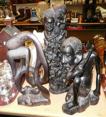 Lot 180 - A Makobe, Tanzania ebony carving of the tree of life, a similar figure of a crouching man and a...